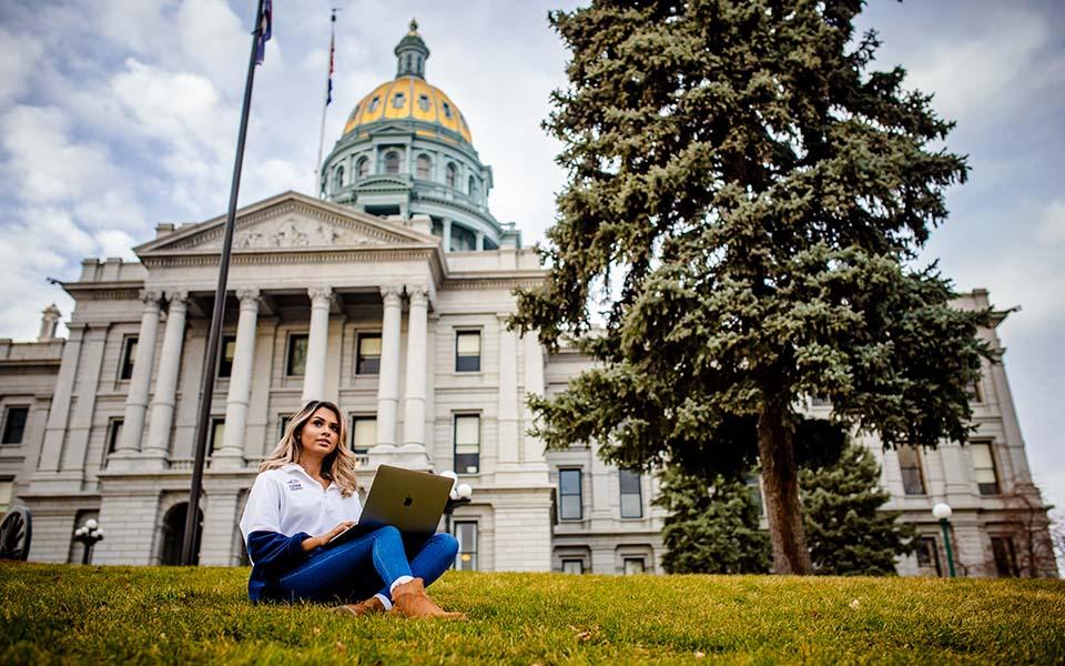 Online student studying outside Denver capitol